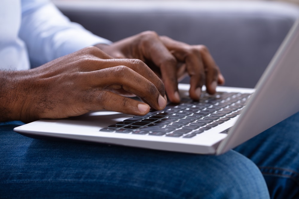 person typing on laptop