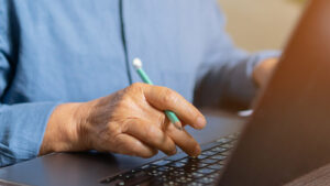 close up on mature woman working on laptop