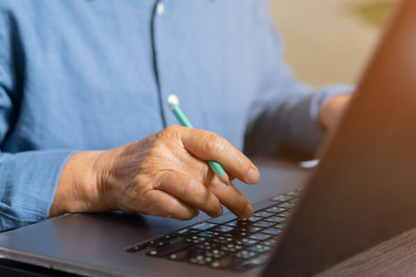 close up on mature woman working on laptop