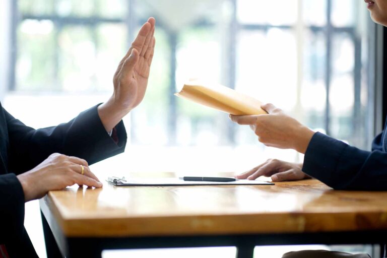 A person refused to accept the money bribe envelope
