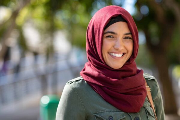 Closeup face of a woman covered with headscarf smiling