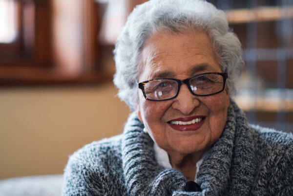 Portrait,Beautiful,Elderly,Woman,Smiling,Sitting,On,Sofa,At,Home