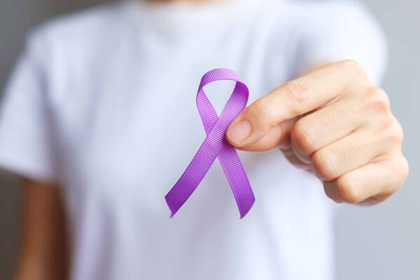Hand,Holding,Purple,Ribbon,For,Pancreatic,,Esophageal,,Testicular,Cancer,,World