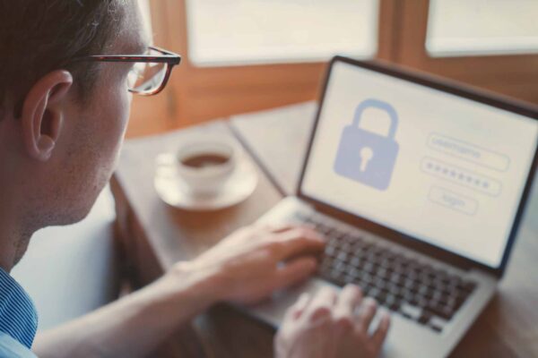 Man typing login and password on computer