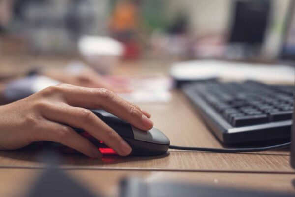 Closeup,Of,Hands,Using,Computer,Mouse,With,Computer,Desktop,Pc