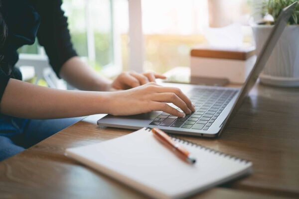 Closeup,Hands,Of,Business,Woman,Working,On,Laptop,And,Using