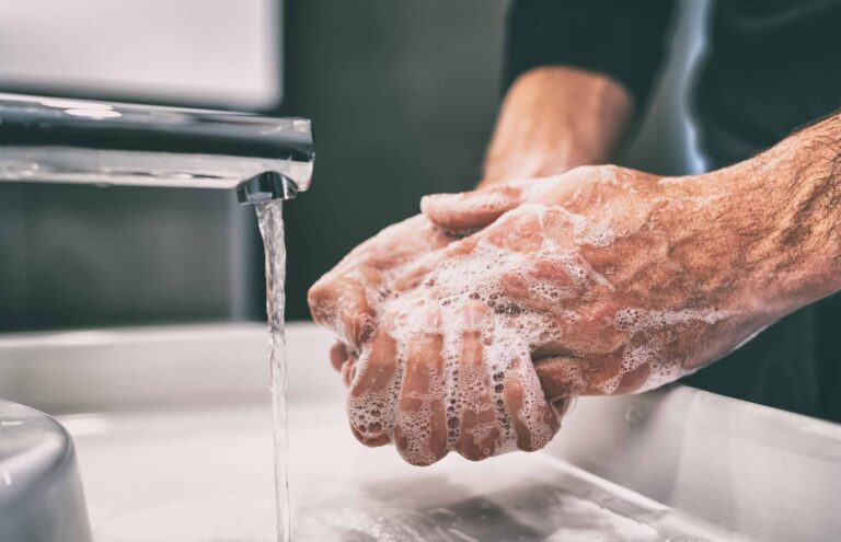 Man washing his hands in the sink