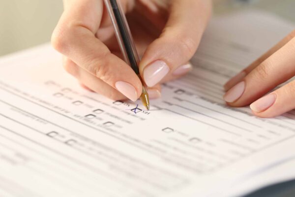 Close,Up,Of,Woman,Hands,Filling,Form,Crossing,Yes,Checkbox