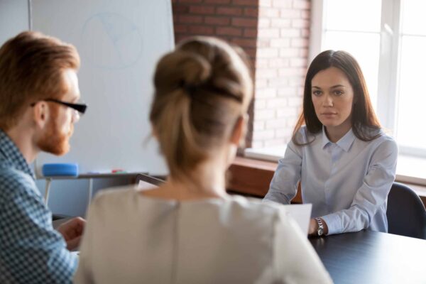 Serious,Attentive,Female,Boss,Listening,To,Employees,Reporting,About,Work