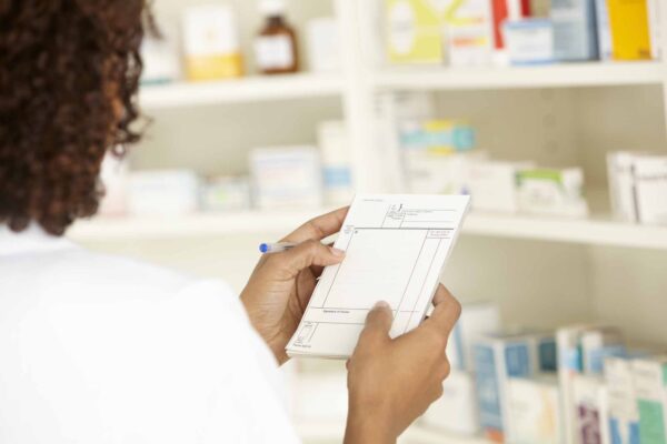 Uk,Female,Nurse,In,Pharmacy,With,Prescription