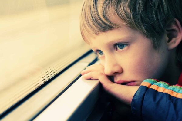 Cute,Boy,Looking,Through,The,Window