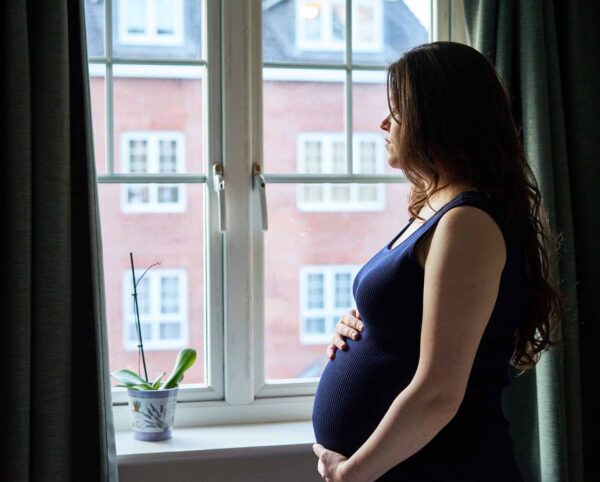 Maternity,Portrait,In,Front,Of,Window,In,Uk