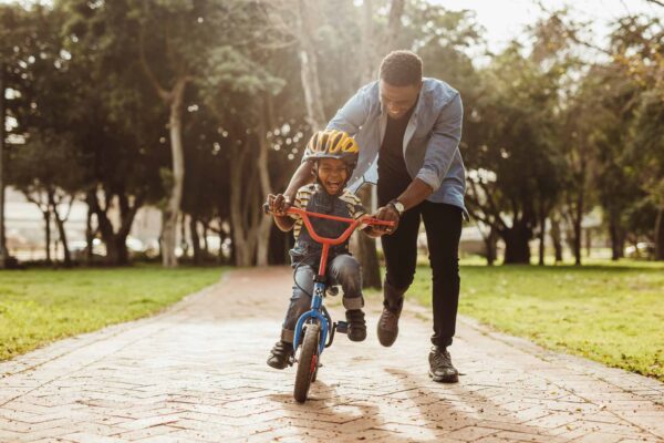 Boy,Learning,To,Ride,A,Bicycle,With,His,Father,In