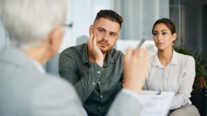 Young couple having a meeting with a woman