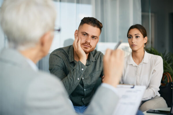 Young couple having a meeting with a woman