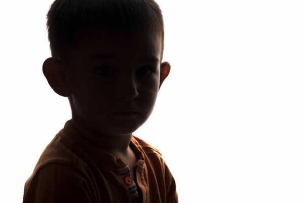 silhouette of the face of an unknowable little sad boy