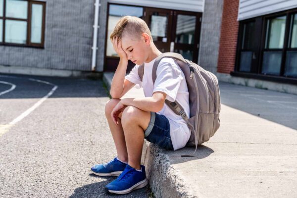 A,Very,Sad,Boy,Bullying,In,School,Playground.