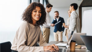 Woman sitting at the office table with group of colleagues