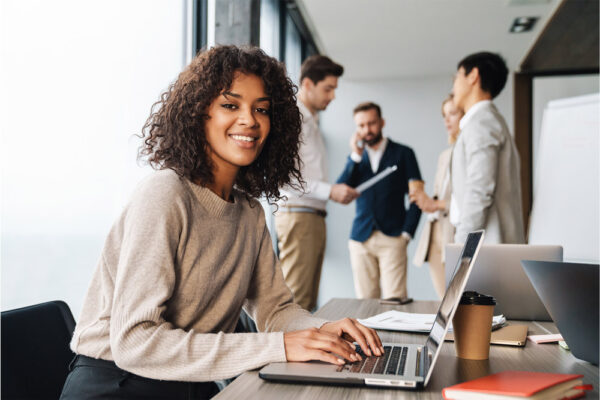 Woman sitting at the office table with group of colleagues