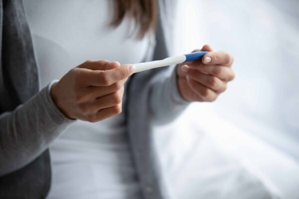 Close,Up,Cropped,Image,Woman,Holding,Plastic,Pregnancy,Test,Kit