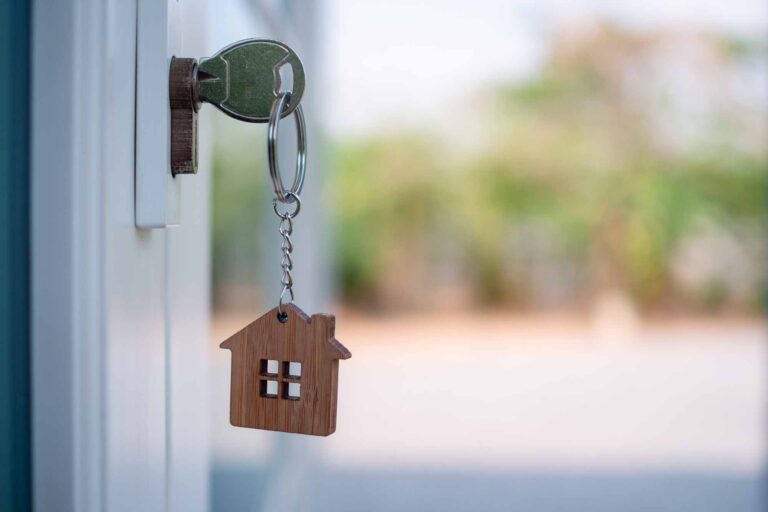 Wooden house key chain in door