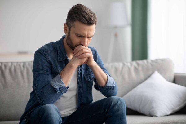 Upset man sitting on the sofa