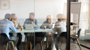 Colleagues brainstorming at modern office boardroom behind closed doors