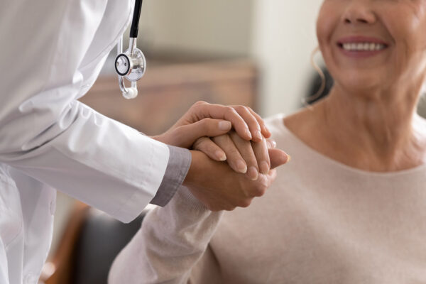 doctor and patient holding hands