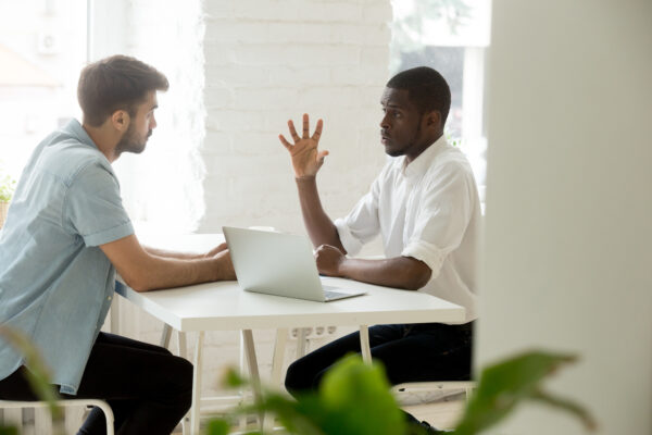 Focused,Multiracial,Businessmen,Working,Together,In,Modern,Office,,Talking,Sharing