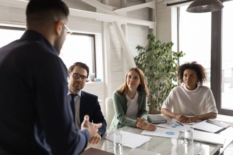 a group of people in a meeting. Performance management workshop
