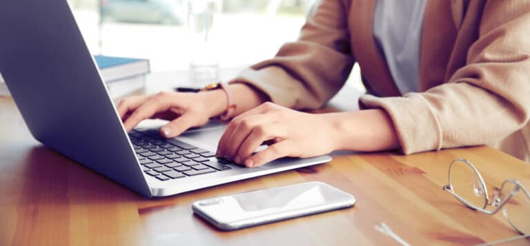 woman typing on laptop