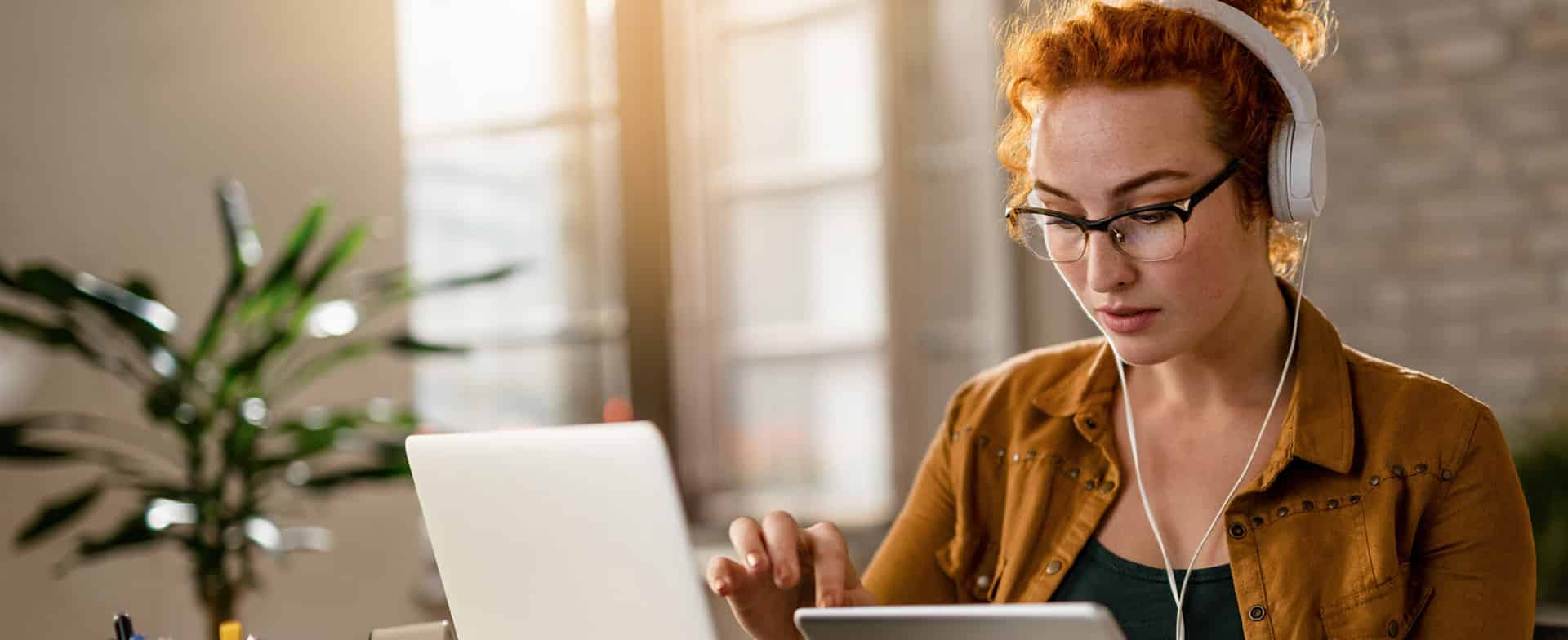 Woman using assistive technology with headphones on