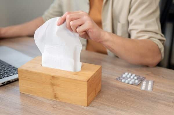 Person grabbing a tissue