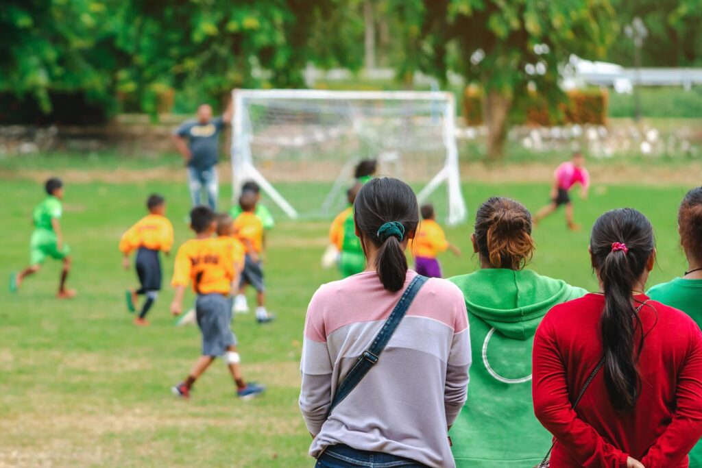 parents watching kids football game