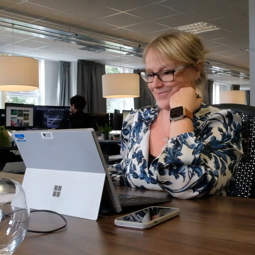 Woman smiling at laptop screen