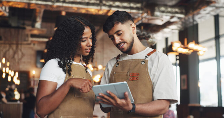 workers at cafe training on tablet